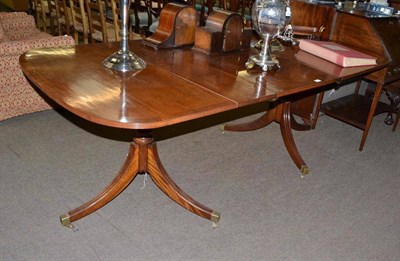 Lot 807 - A Regency style mahogany pedestal dining table with extra leaf, 212cm long