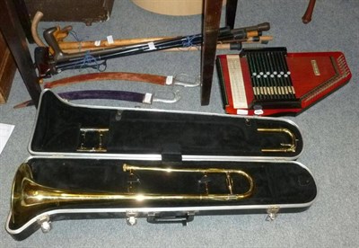 Lot 828 - A cased trombone, table harp, two swords and walking sticks