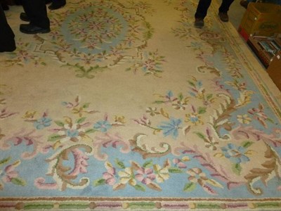 Lot 876 - An Indian carpet of Savonnerie design, the beige field centred by a leafy floral medallion...