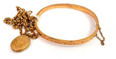 Lot 25 - A 9ct gold half engraved bangle and a locket on chain