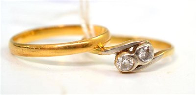 Lot 26 - A 22ct gold band ring (out of shape) and a diamond two stone twist ring, with platinum fronted...