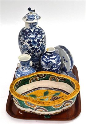 Lot 74 - A Chinese blue and white squat vase decorated with foliage, Kangxi mark to base, a small vase...