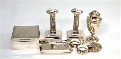 Lot 107 - Pair of silver dwarf candlesticks, purse, feeding spoon, caster, pair of napkin rings, sugar...