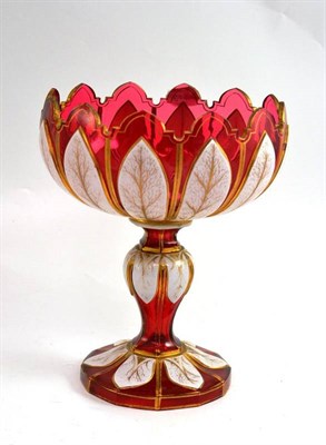 Lot 147 - A Bohemian overlaid cranberry glass comport highlighted in gilt