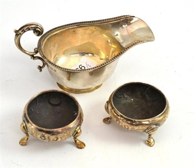 Lot 166 - A silver sauce boat and pair of salts