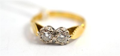 Lot 185 - A diamond two stone ring, the round brilliant cut diamonds in white illusion settings to yellow...