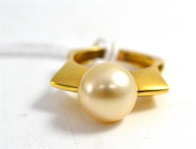 Lot 224 - An 18ct gold contemporary South Sea pearl ring, the pearl held in a shaped shank, with pierced...