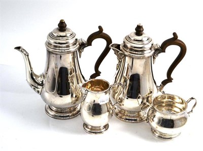 Lot 227 - A silver four piece tea service comprising tea pot, hot water jug, milk jug and sugar bowl