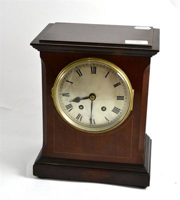 Lot 230 - An Edwardian mahogany mantel clock with boxwood stringing, silvered dial and Roman numerals,...