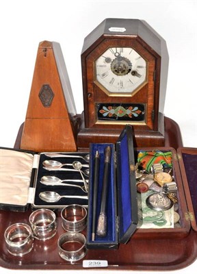 Lot 239 - A mounted timepiece, metronome, four silver napkin rings, medals, Timex wristwatch, cased set...