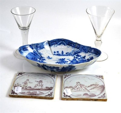 Lot 242 - An 18th century wine glass, another modern glass, two manganese decorated tiles and a pearlware...