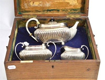 Lot 245 - A silver three piece tea service in original fitted case