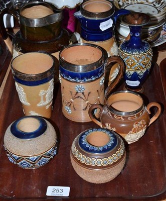 Lot 253 - A collection of Doulton stoneware, comprising a jug, decorated with Topers with a silver...