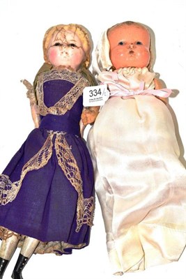 Lot 334 - Wax head doll with painted and carved wood lower arms and legs, and composition doll (2)