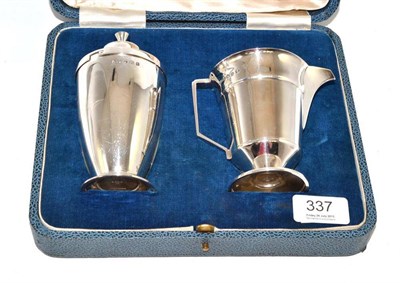 Lot 337 - A silver sugar caster and the matching cream jug, in their original presentation case from Edward &