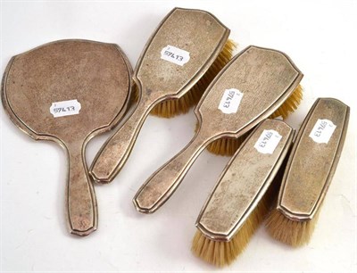 Lot 339 - A set of four silver backed brushes and a silver backed mirror