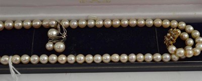 Lot 341 - A strand of cultured pearls with a star clasp and a pair of clip-on earrings