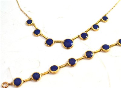 Lot 358 - A lapis lazuli necklace and bracelet, round polished lapis lazuli stones in yellow bezel...