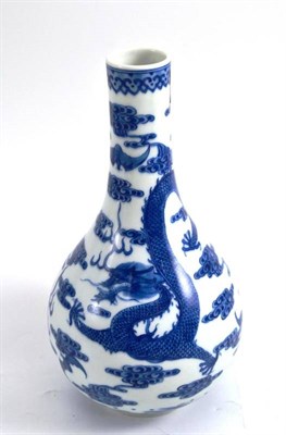 Lot 373 - A Chinese blue and white porcelain bottle vase painted with a five claw dragon amongst clouds...