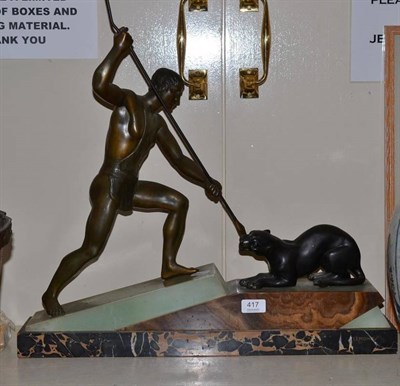 Lot 417 - An Art Deco spelter figure of a hunter and a panther, on a shaped marble veneered base, signed...