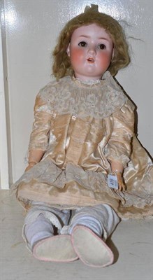 Lot 419 - Schoenau and Hoffmeister bisque socket head doll impressed 914, with original wig, sleeping...