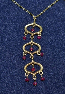 Lot 444 - An 18ct gold ruby chandelier pendant on a chain