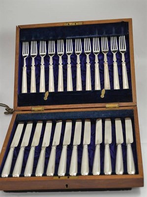 Lot 450 - A set of silver bladed fish knives and forks (plated tines to forks)