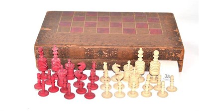 Lot 473 - A stained and natural ivory chess set, in a book-form chess and backgammon case, king 9cm high