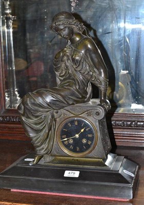 Lot 479 - A Victorian mantel clock, the black slate base mounted with a spelter figure of a woman...