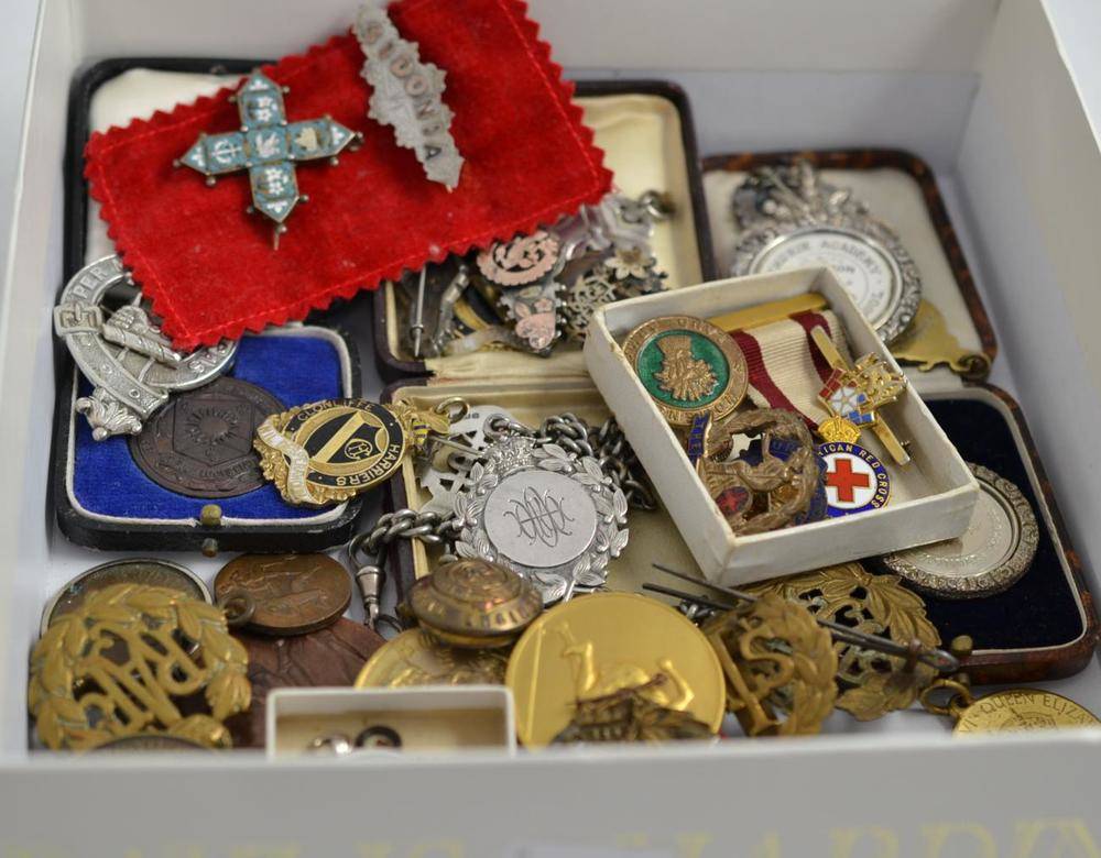 Lot 4 - A collection of military cap badges, sweetheart and other brooches, sports medallions, Royal...