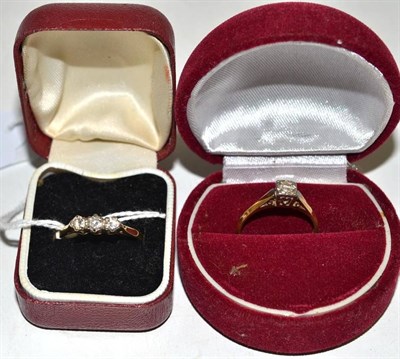 Lot 12 - A 18ct gold diamond three stone ring and a diamond solitaire ring, stamped '18CT' and 'PLAT'