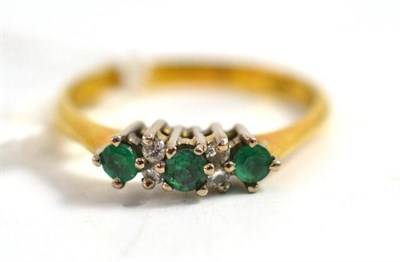 Lot 22 - An emerald and diamond half hoop ring