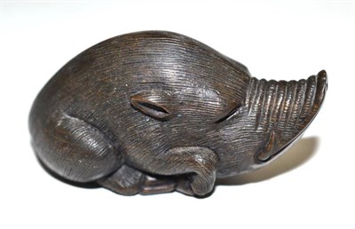 Lot 37 - A Japanese carved horn netsuke in the form of a warthog, signed to an ivory panel underneath