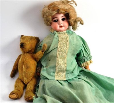 Lot 55 - An Armand Marseille bisque headed doll and a small teddy bear (2)