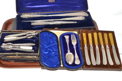 Lot 64 - Cased silver spoon and fork, cased silver spoon, cased set of nut crackers and picks, cased carving