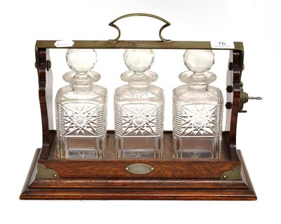 Lot 76 - An oak and silver plated three bottle tantalus