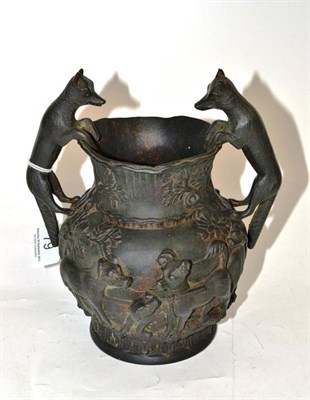 Lot 79 - A bronze two handled vase cast with hounds and foxes