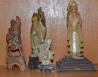 Lot 108 - Three carved soapstone figures and a carved horn figure