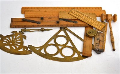 Lot 114 - Two brass inclinometers, eight boxwood rules, a fruitwood gavel and a brass measure