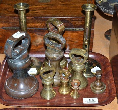 Lot 198 - A composite set of brass bell and flat weights and a pair of Georgian brass telescopic candlesticks