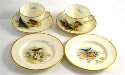 Lot 200 - Two Royal Worcester Trios, painted by W Powell with bird studies, including green woodpecker,...