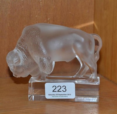 Lot 223 - A modern Lalique frosted glass bison paperweight, on a clear rectangular plinth, script mark,...