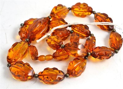 Lot 257 - A strand of shaped amber beads