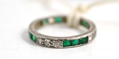 Lot 258 - An emerald and diamond full eternity ring (a.f.) (very worn - some stones missing and setting weak)