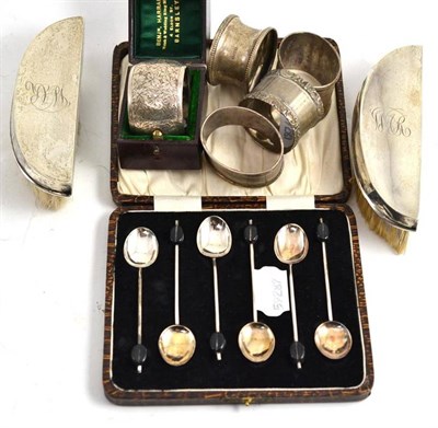 Lot 261 - Two silver backed hair brushes, five napkin rings, six coffee spoons and a silver clip