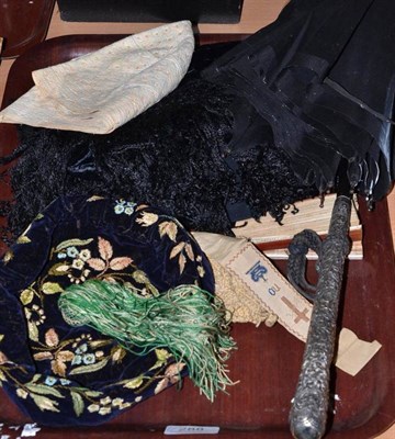 Lot 288 - A silver handled umbrella, an embroidered smoking cap, another cap, a pair of bootees, a black lace