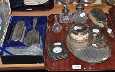 Lot 299 - A silver cased dressing table set of three brushes and a mirror, another brush, tray, watch...