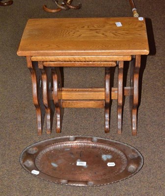 Lot 342 - A nest of three Arts & Crafts style oak tables and an Arts & Crafts oval tray