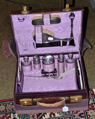 Lot 376 - A silver mounted glass travelling set in leather case with canvas outer case