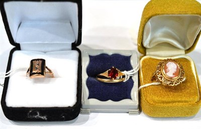 Lot 390 - A 9ct gold cameo ring, a band ring and a stone set ring and an initial ring